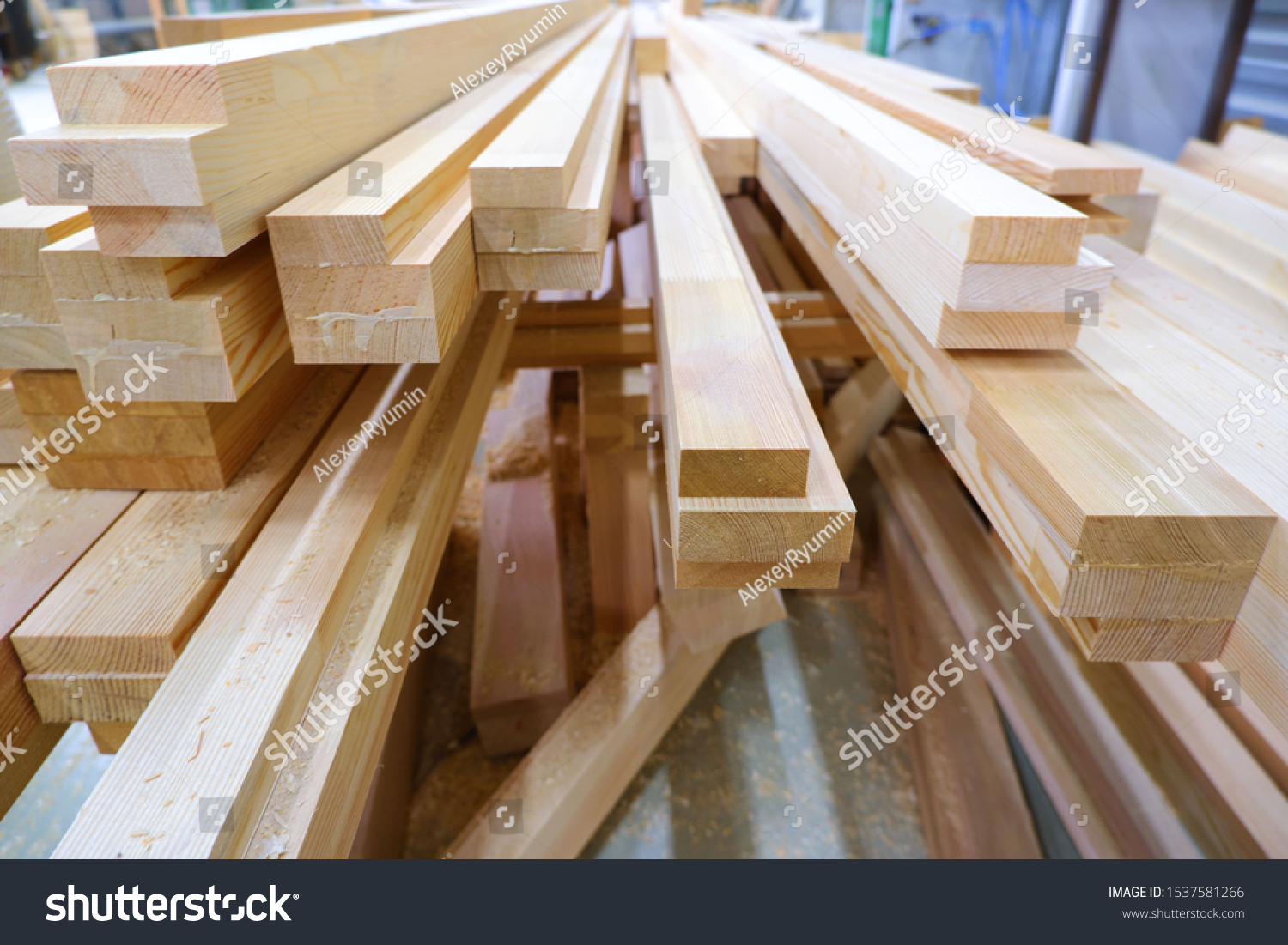 View from butt of stack of three-layer wooden glued laminated timber beams from pine finger joint spliced boards for wooden windows