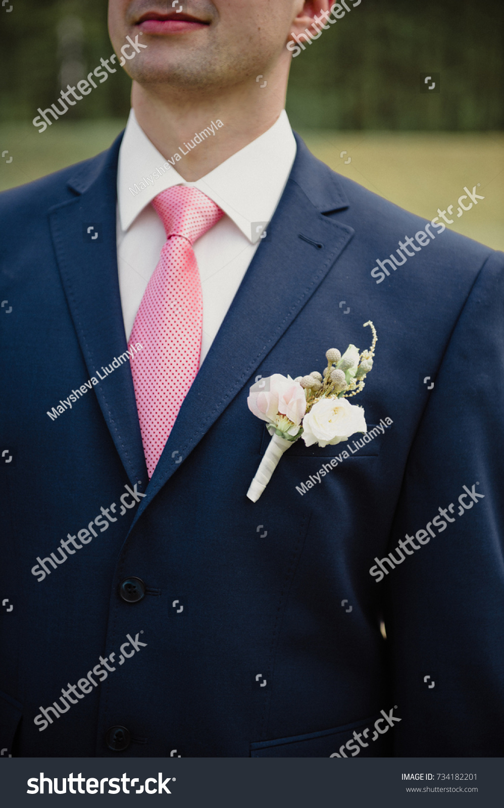 blue suit with light pink tie