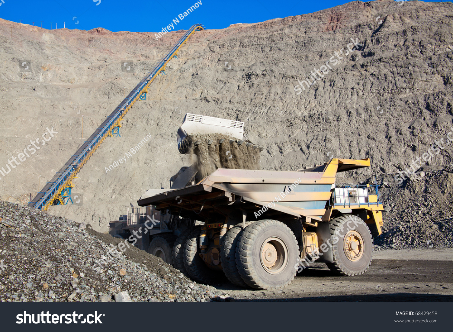 Wheel Front-End Loader Unloading Ore Into Heavy Dump Truck At The ...