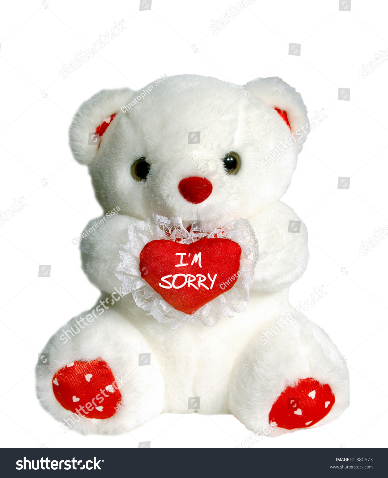 white teddy bear holding a heart