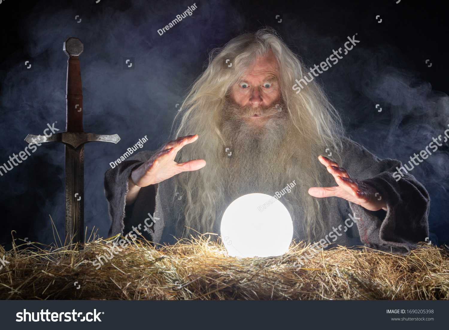 stock-photo-wizard-looking-in-crystal-ball-to-predict-future-1690205398.jpg