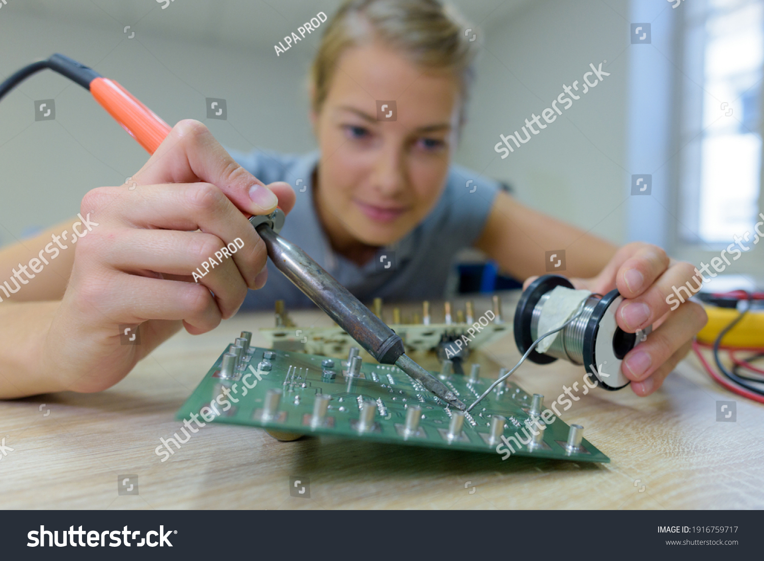 Stock Photo Woman Assembling Works Soldering Iron 1916759717 