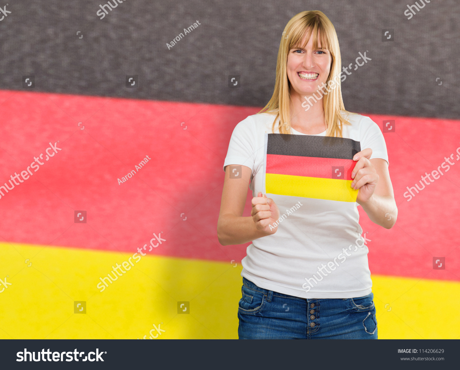 Woman Holding Germany Flag And Standing Against Flag Stock Photo ...