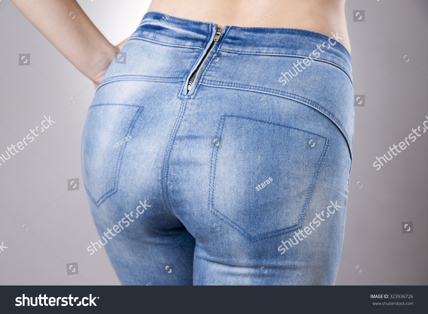 Woman In Jeans Close Up. Beautiful Female Hips And Buttocks On A Gray ...