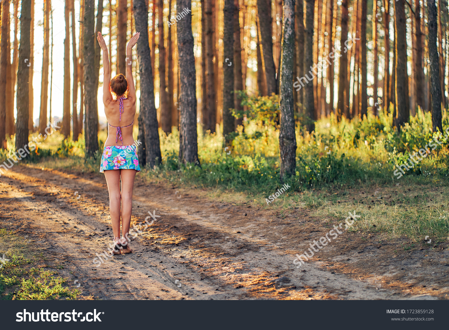 https://image.shutterstock.com/z/stock-photo-woman-in-swimsuit-and-sport-skirt-pulls-hands-to-the-sun-1723859128.jpg