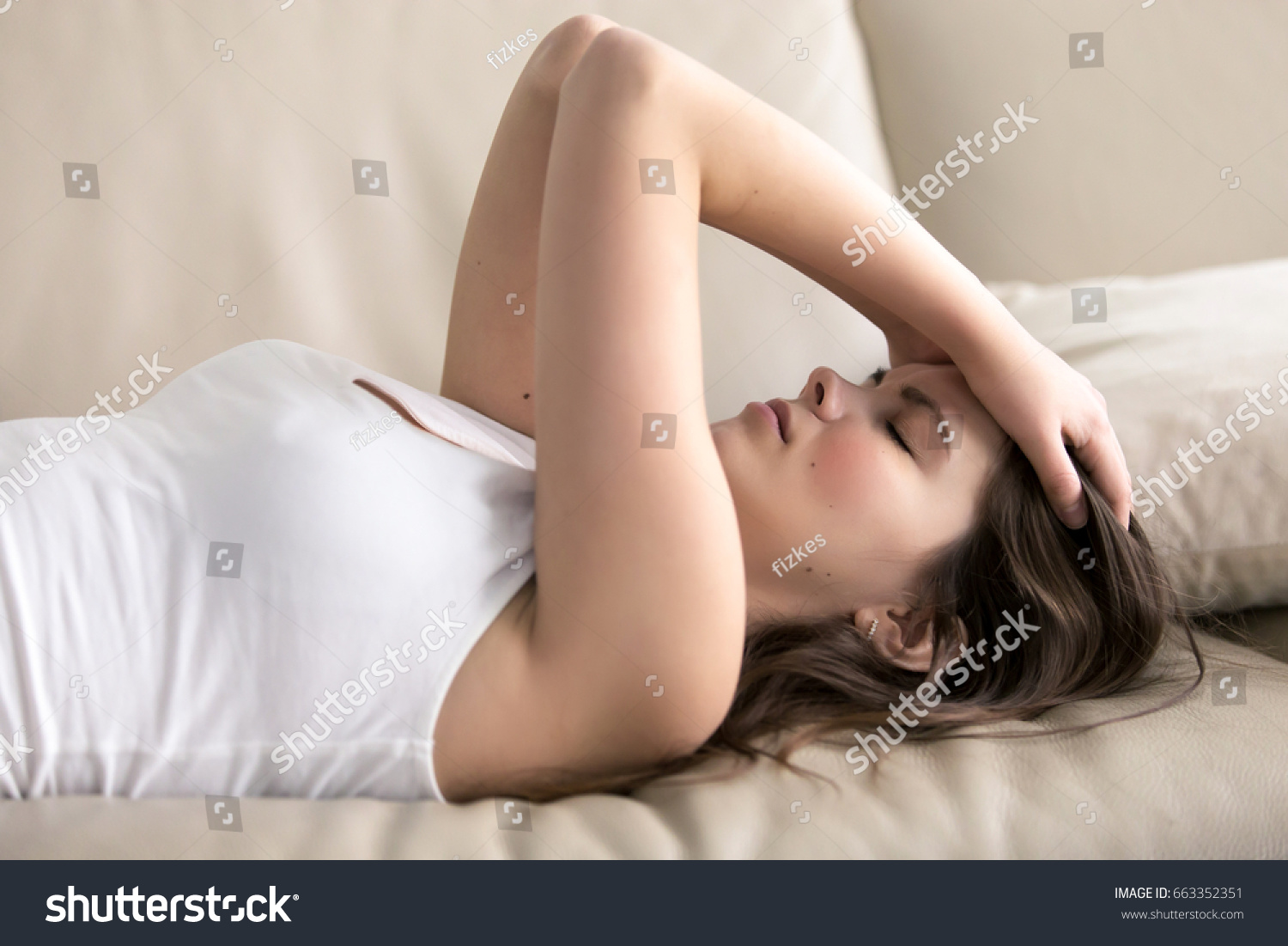 Woman Lying On Sofa Having Headache Stock Photo Safe To Use