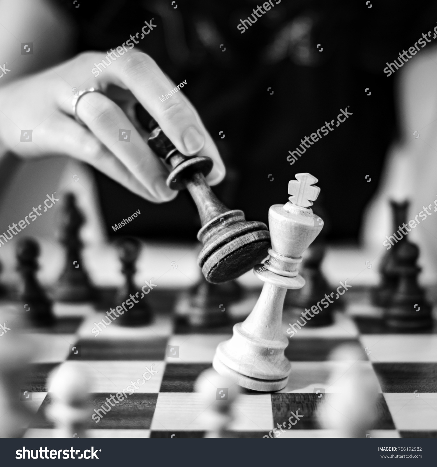 Defeating the white king taking the black queen in her hand