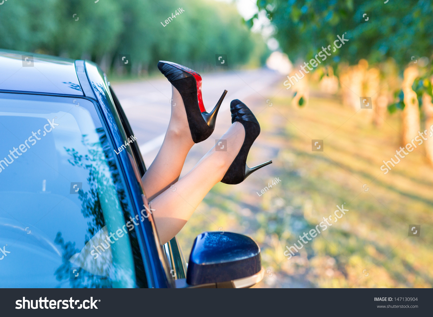 Woman'S Legs In High Heel Shoes Out In A Car Window Outdoor Stock Photo ...