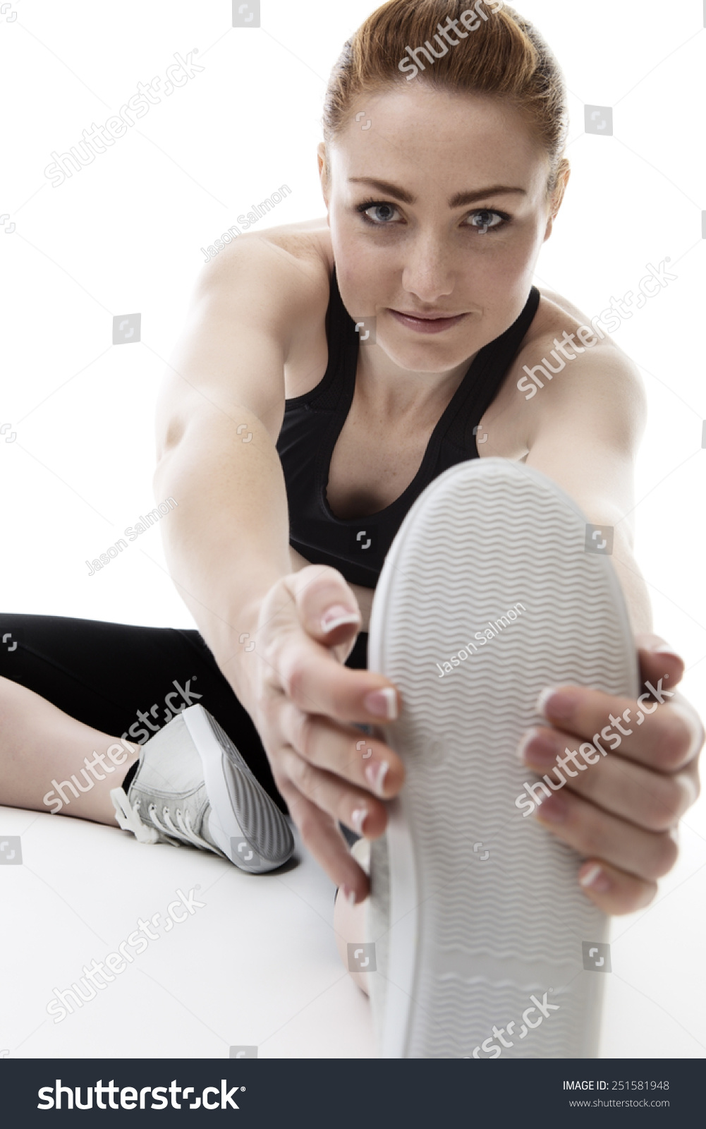 Woman Sitting On Floor Stretching Her Stock Photo 251581948 | Shutterstock