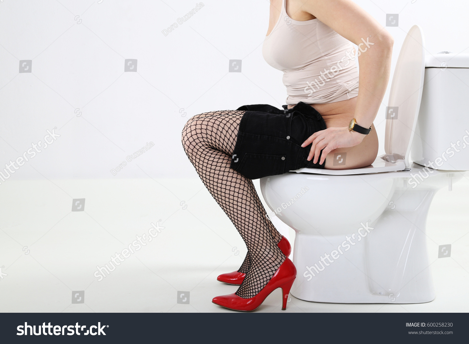 Young Woman Sitting On Toilet Stock Photo 225935416 