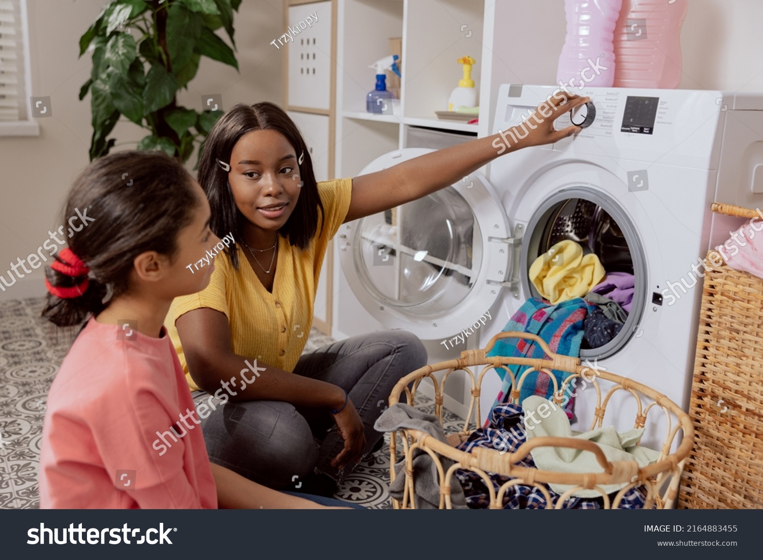 Woman Spends Time Younger Sister Laundry Stock Photo 2164883455 ...