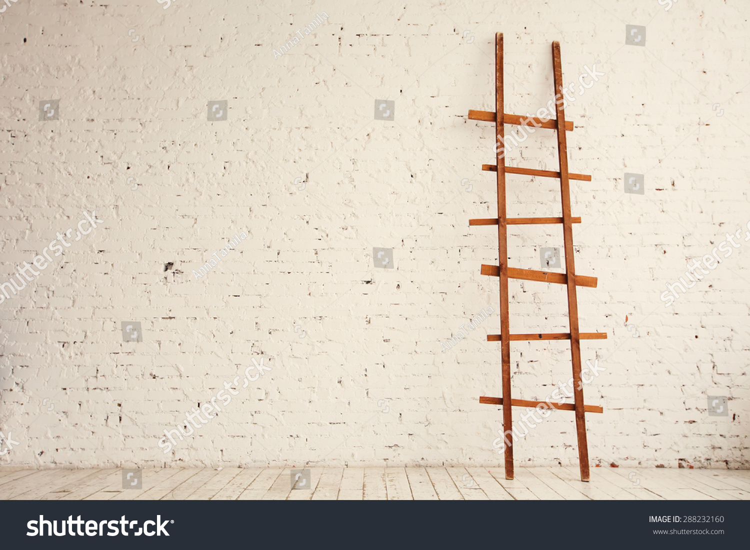 Wooden Ladder Near White Brick Wall In Empty Room Ready For Renovation