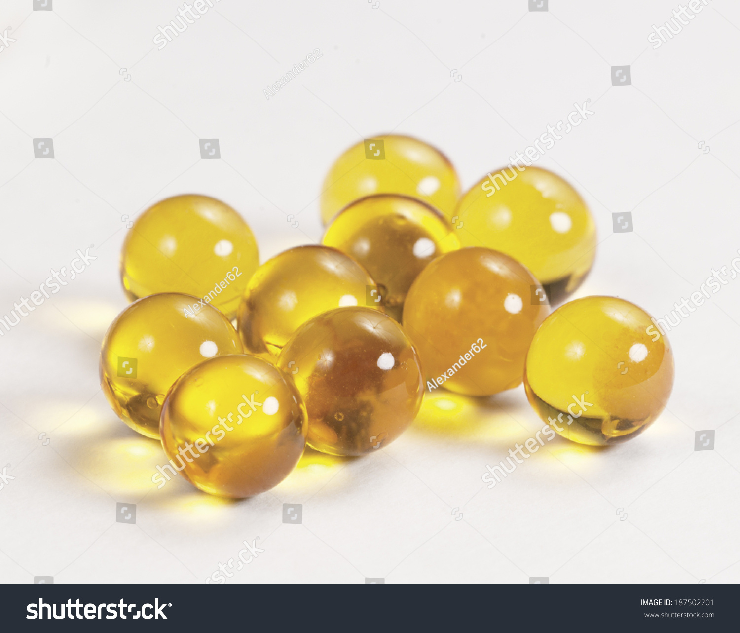 Download Yellow Capsules Near Box Over Light Stock Photo Edit Now 187502201 PSD Mockup Templates