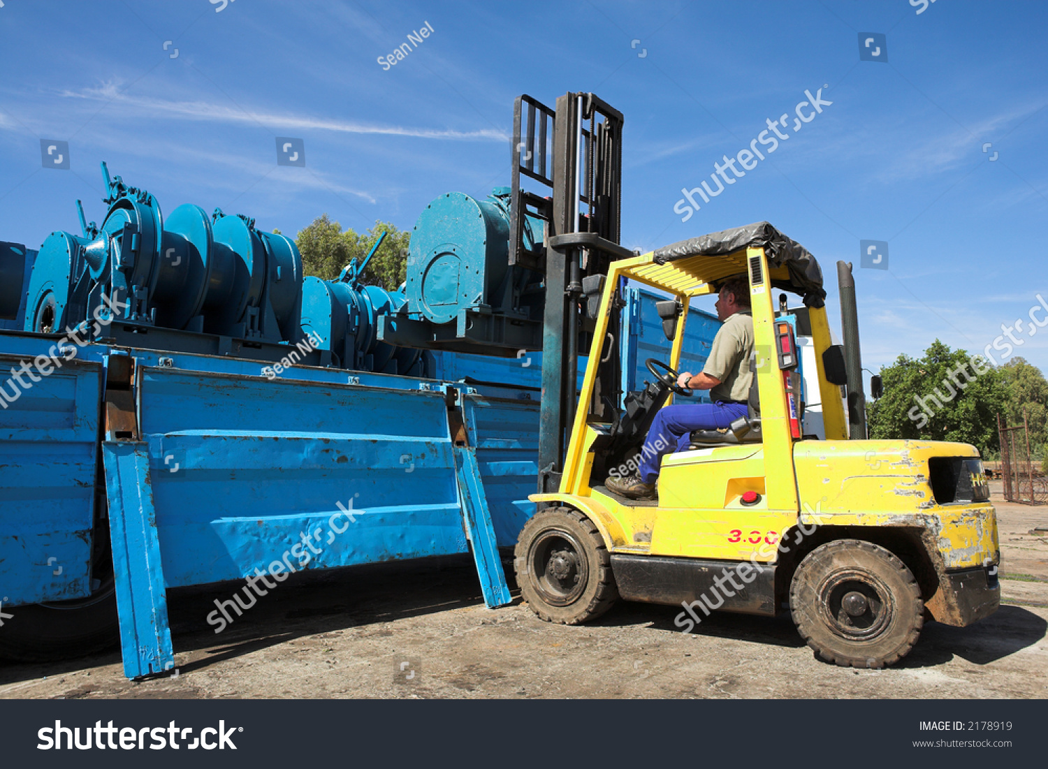 Yellow Forklift Placing Cargo On Flatbed Industrial Stock Image 2178919