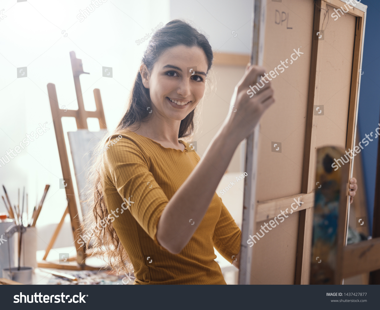 Young Artist Putting Canvas On Easel Royalty Free Stock Image