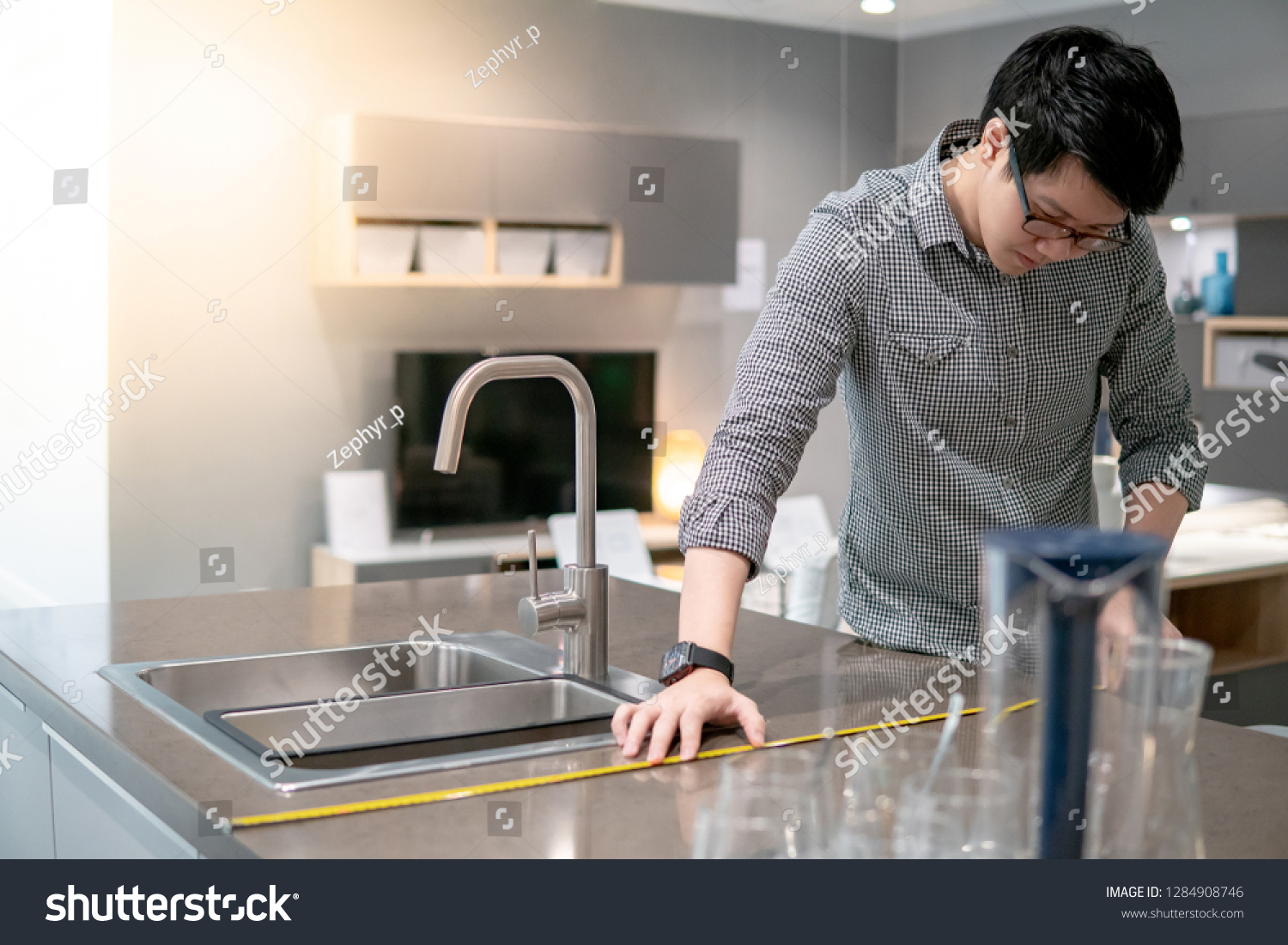Young Asian Man Using Tape Measure Stock Photo Edit Now 1284908746