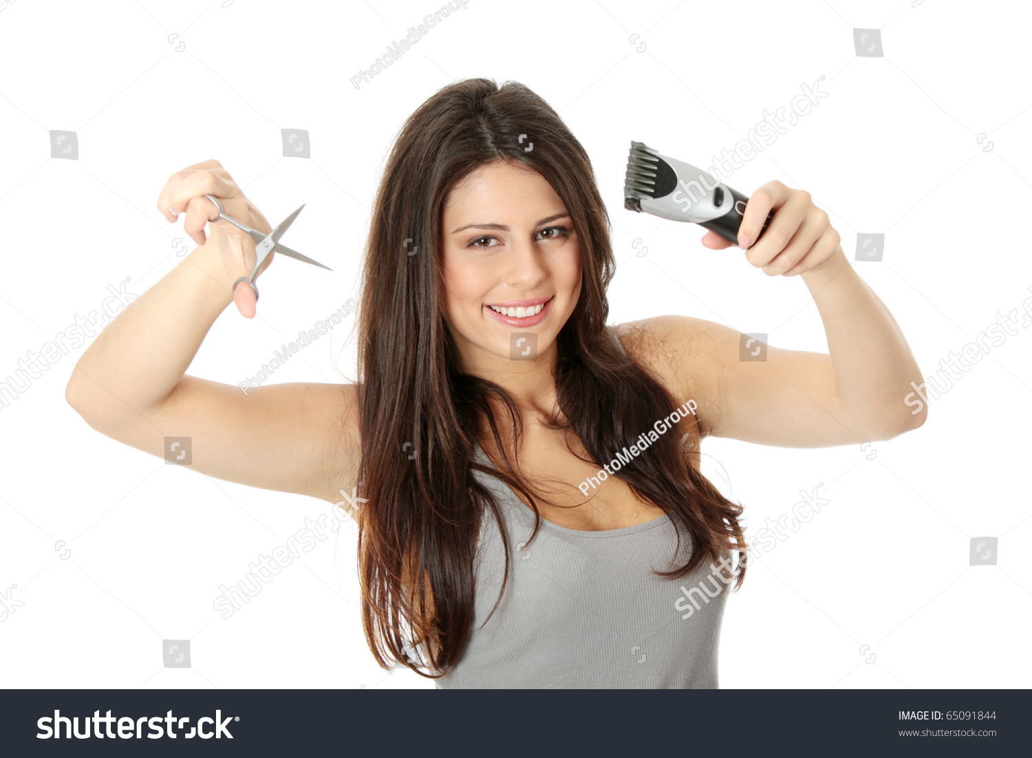 Young Beautiful Female Hairdresser Holding Scissors And Hair Clipper ...