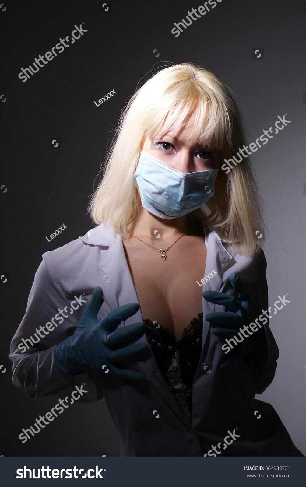 Young beautiful girl in nurse costume posing at studio.Isolated portrait