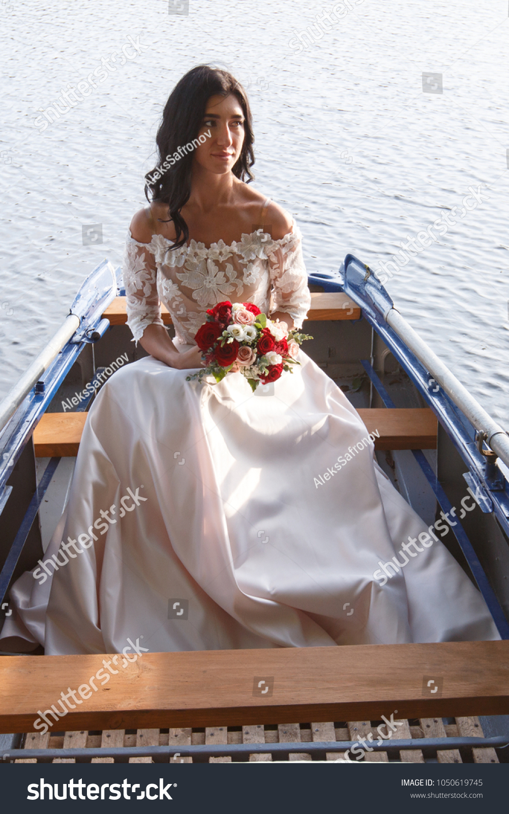 https://image.shutterstock.com/z/stock-photo-young-beautiful-russian-bride-with-long-hair-sitting-in-a-boat-and-holding-a-beautiful-wedding-1050619745.jpg