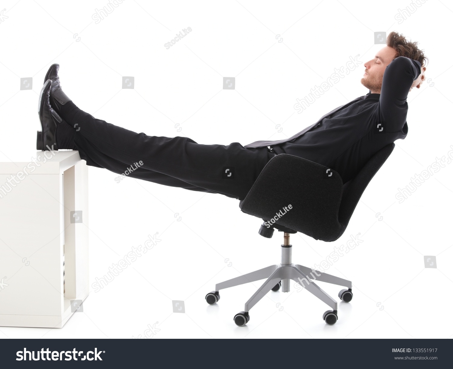 Young Businessman Sitting On Chair, Resting With Legs On Desk, Eyes ...