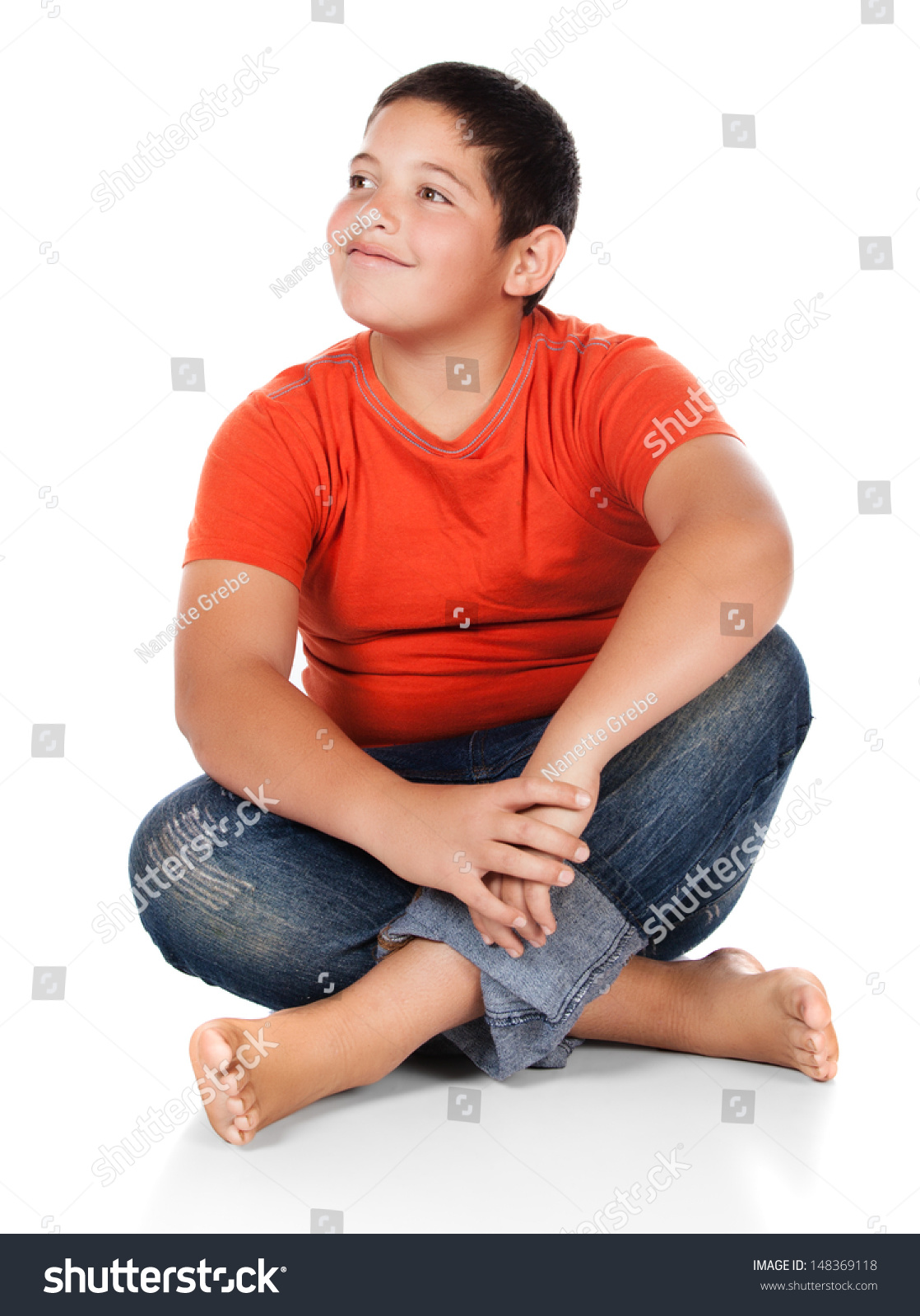 Young Caucasian Boy Wearing An Orange T-Shirt And Blue Jeans. The Boy ...