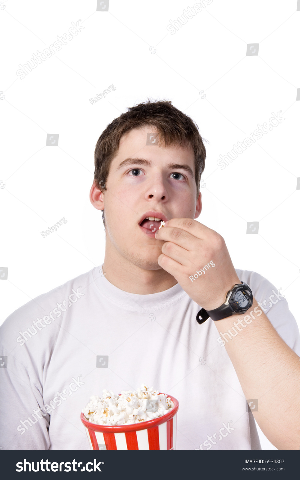 Young Caucasian Man Eating Popcorn While Watching A Movie, Isolated On ...