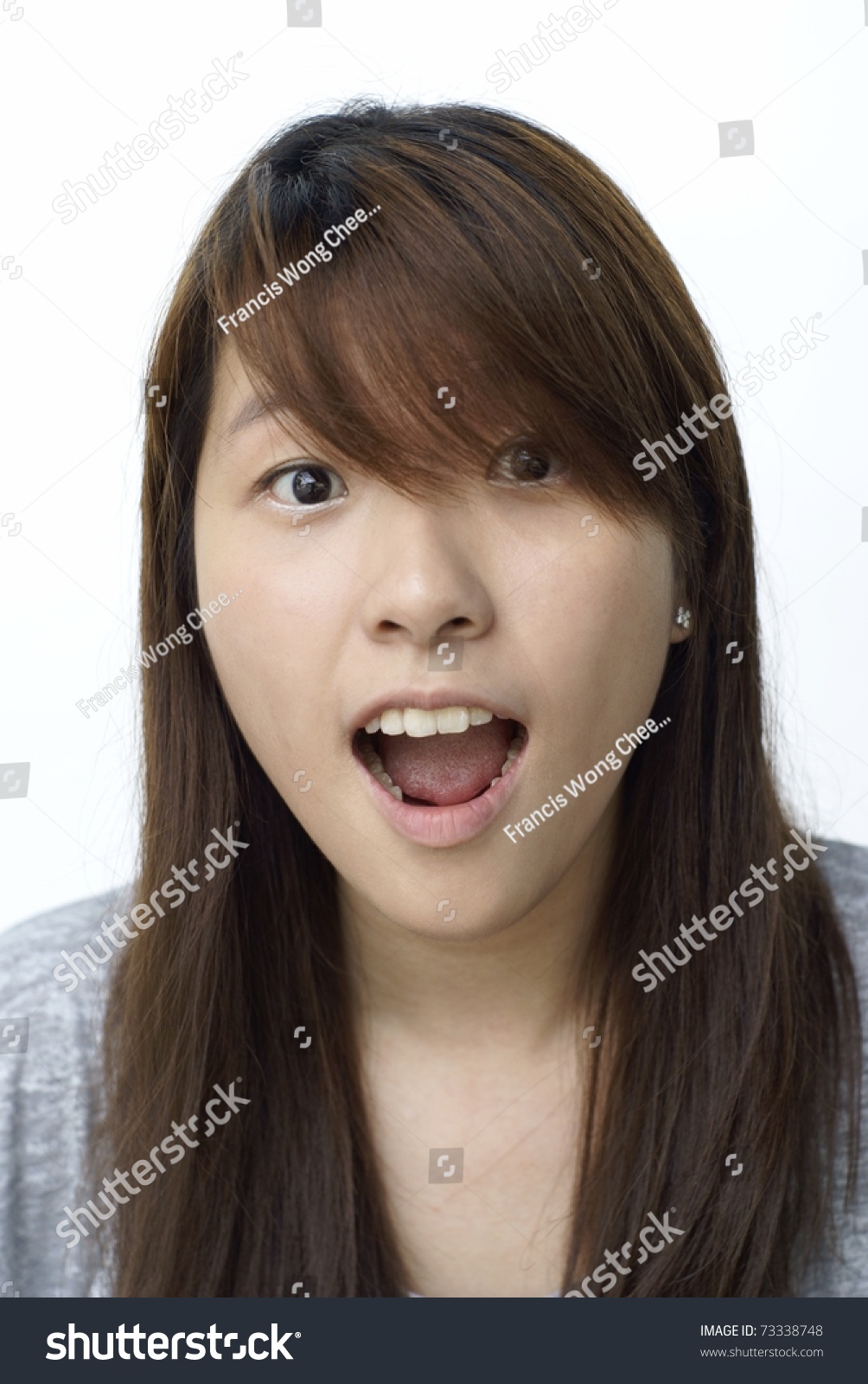 Young Chinese Lady With Surprised Look On White Background In Vertical ...