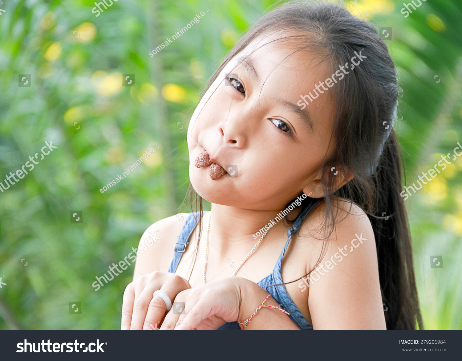 Young Cute Girl With Cookies In Mouth Look Like Rabbit Stock Photo ...