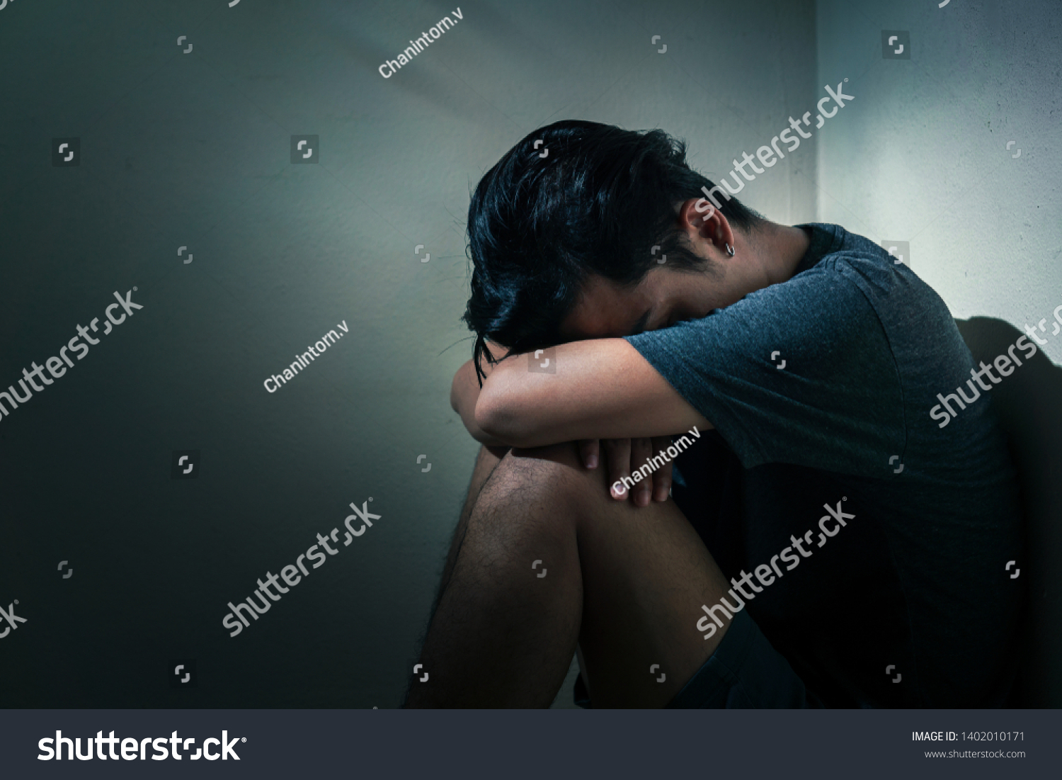 Young Depressed Asian Man Sitting Alone Stock Photo (Edit Now) 1402010171