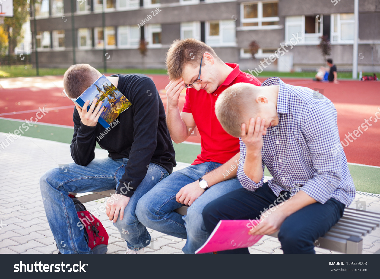 Young Exhausted Students Learning At The School Playing Field. Stock ...