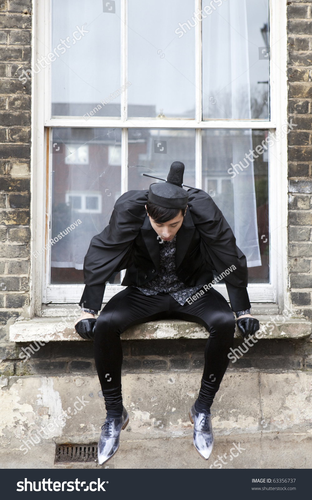 stock-photo-young-fashionable-man-sitting-on-window-sill-and-looking-down-63356737.jpg