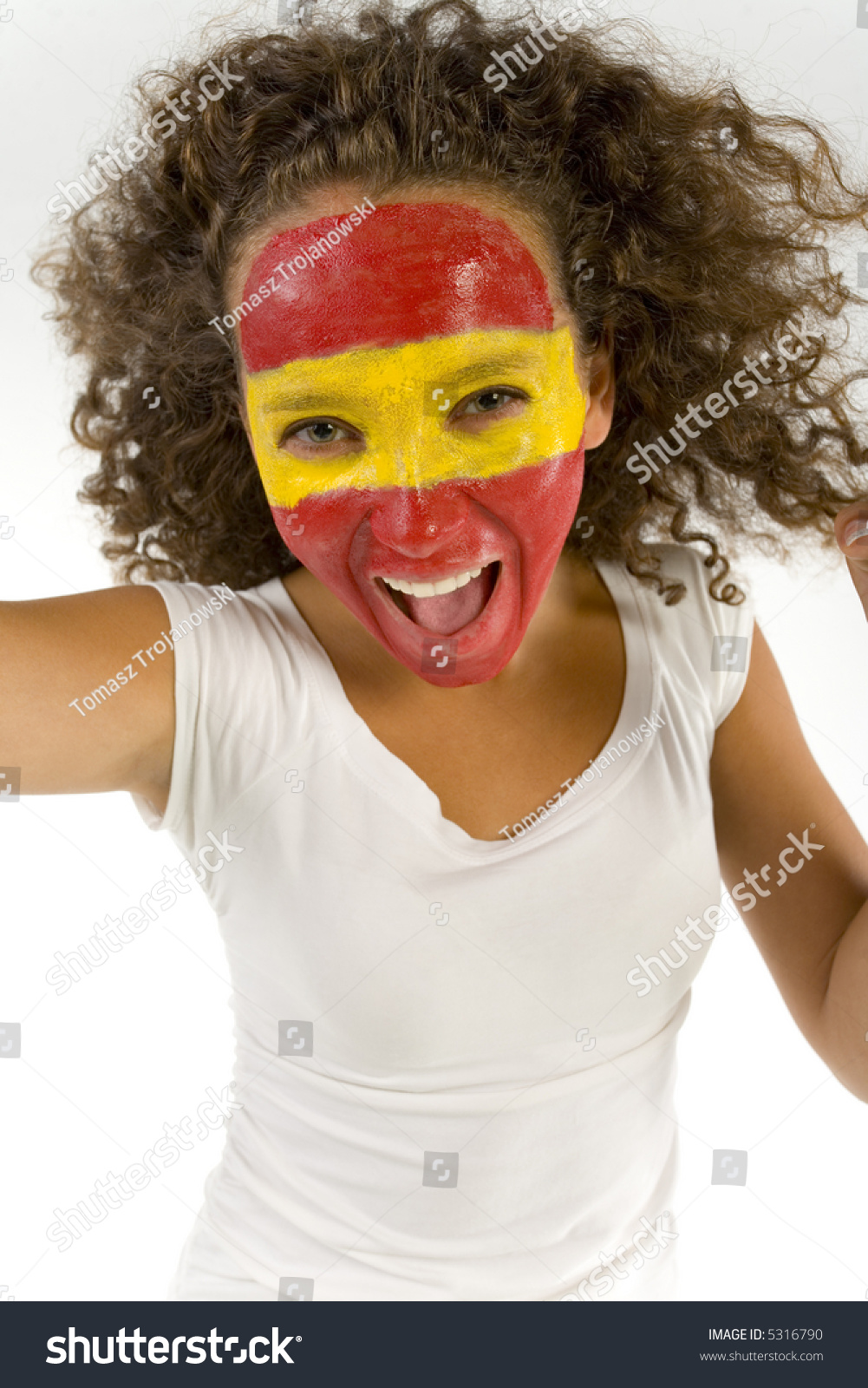 Young Female Screaming Spanish Fan With Painted Flag On Face. She'S On ...