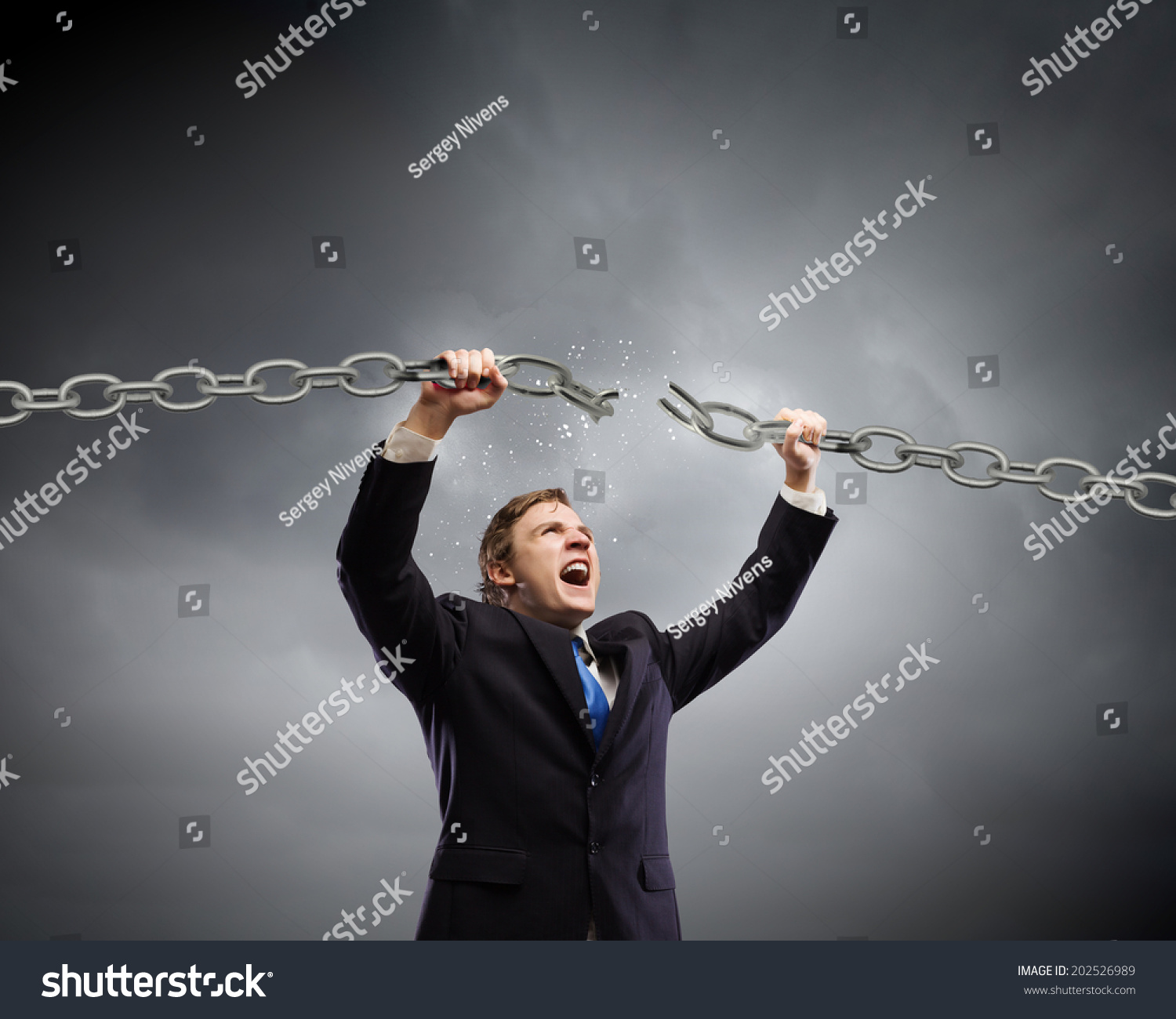 stock-photo-young-furious-businessman-breaking-metal-chain-with-hands-202526989.jpg