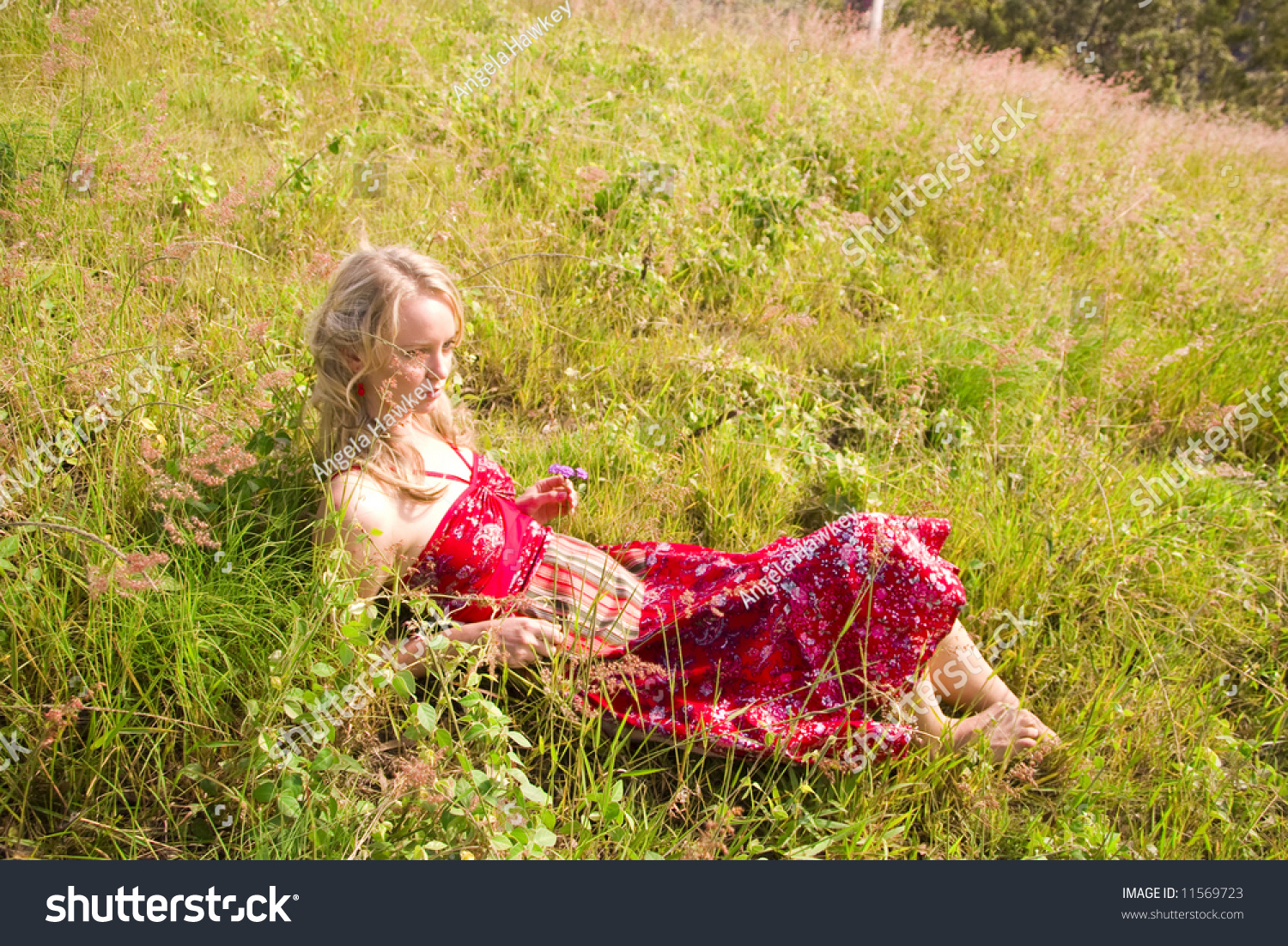 Young Girl Lying In The Afternoon Sun Through The Feild Stock Photo ...