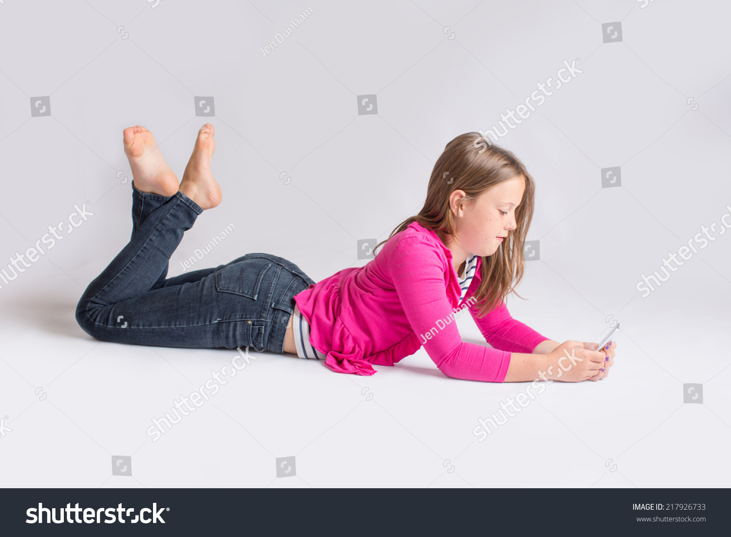 Photo De Stock Young Girl Lying On Stomach While 217926733 Shutterstock 0550