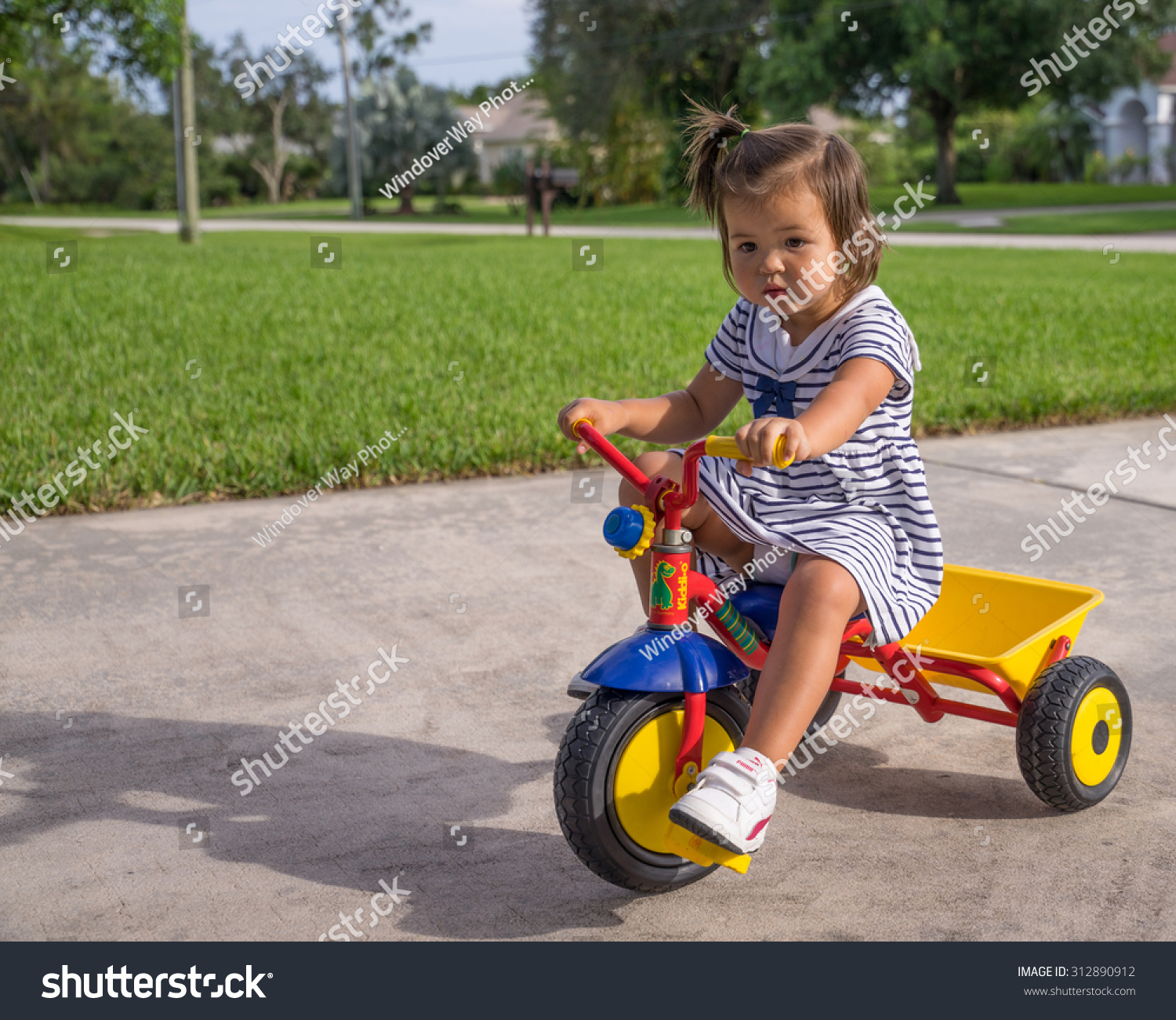 girl riding tricycle