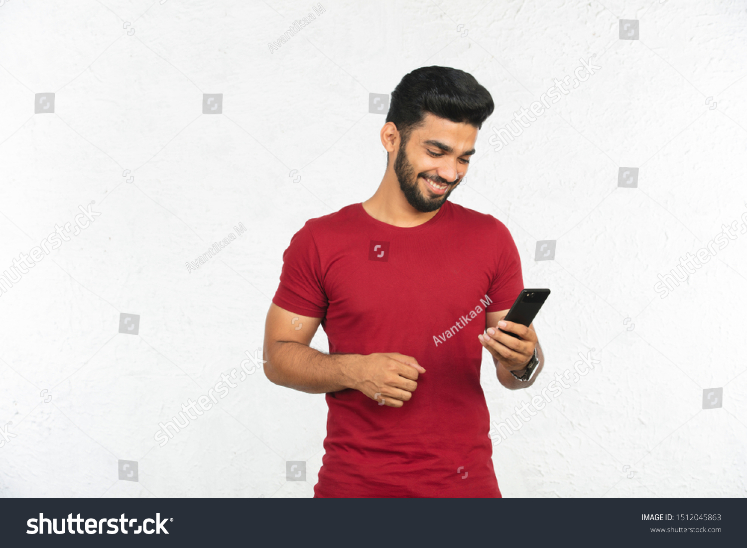 Young Indian Man Holding Phone Smiling Stock Photo 1512045863 ...