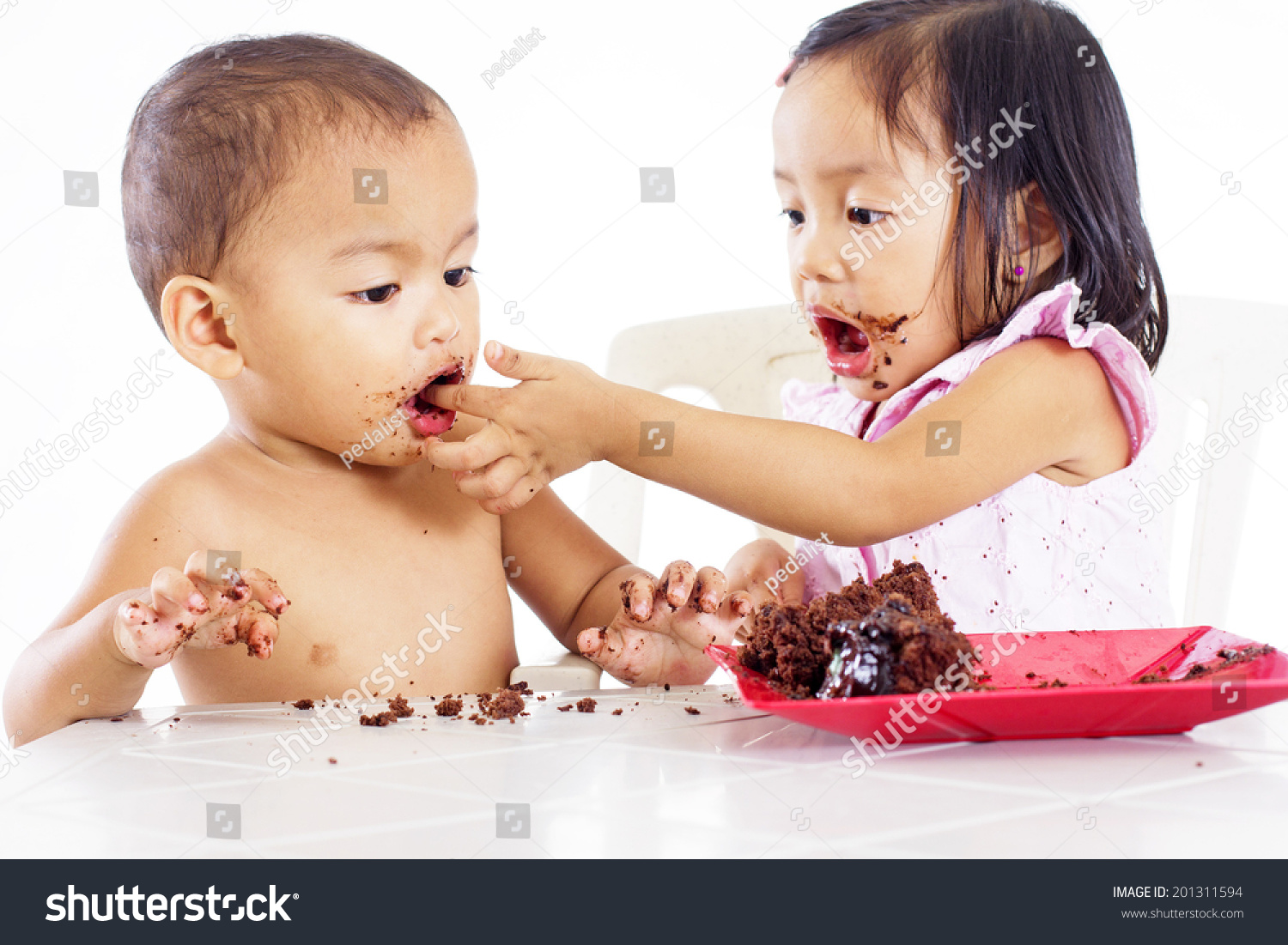 girl feeding boy