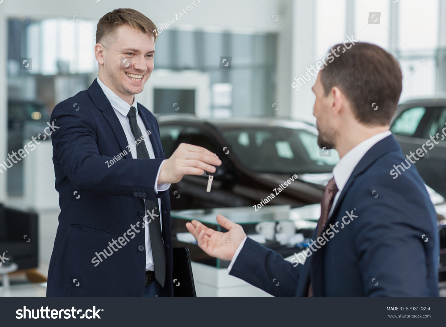 Young Male Car Dealer Smiling Passing Stock Photo Edit Now 679810894