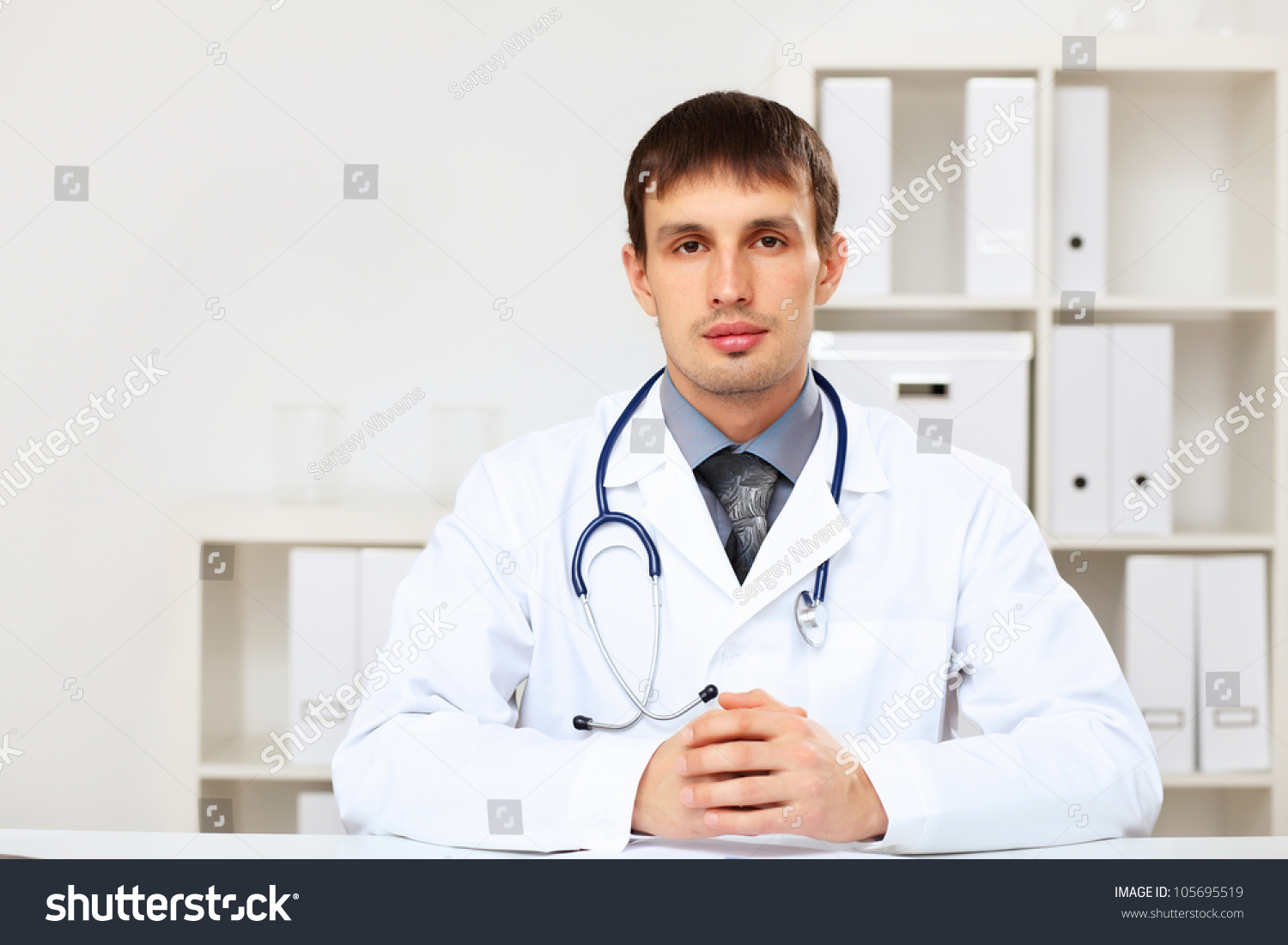 Young Male Doctor In White Uniform At Workplace Stock Photo 105695519 ...