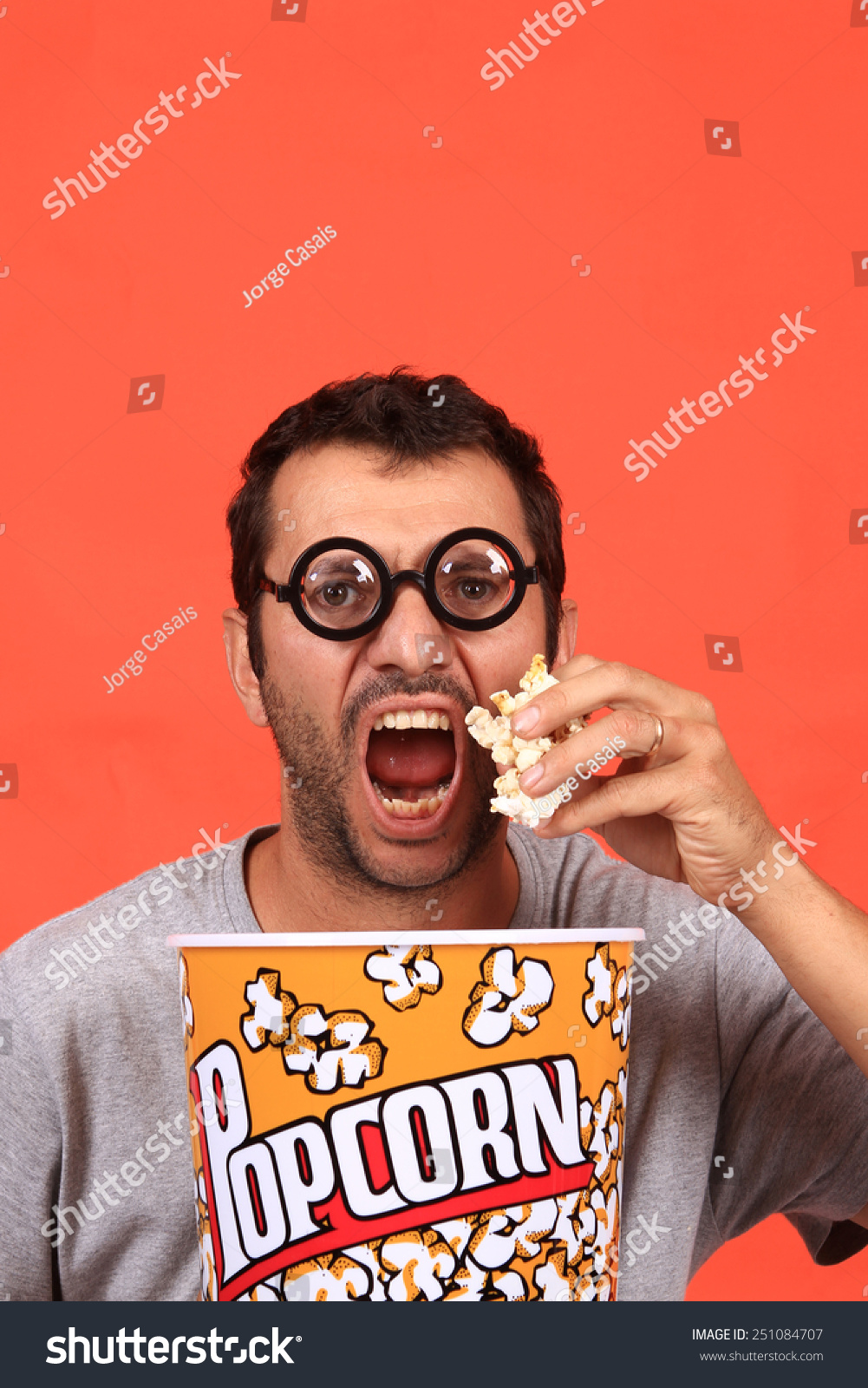 Young Man Eating Popcorn Stock Photo 251084707 : Shutterstock