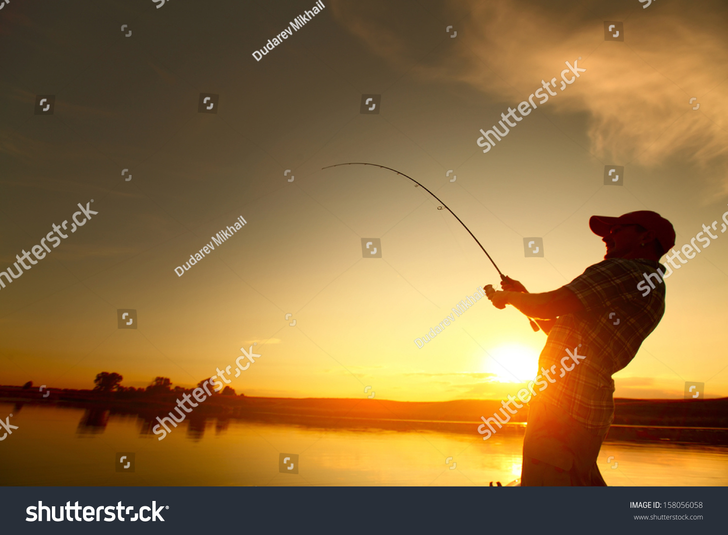 Young Man Fishing From A Boat At Sunset Stock Photo 158056058 ...