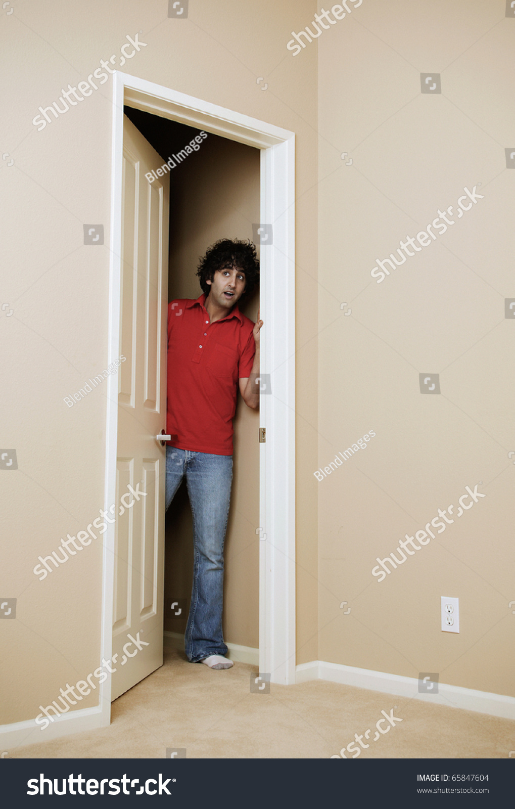 Young Man Peeking Through The Door Stock Photo 65847604 : Shutterstock