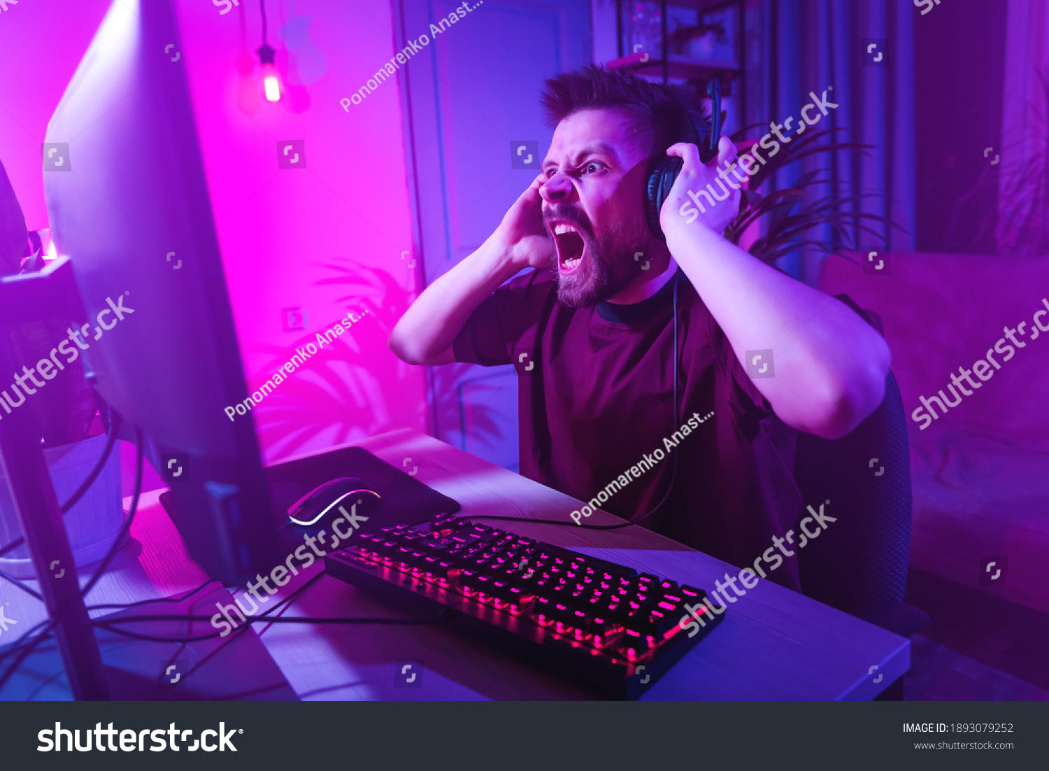 young-man-plays-computer-games-home-stock-photo-1893079252-shutterstock