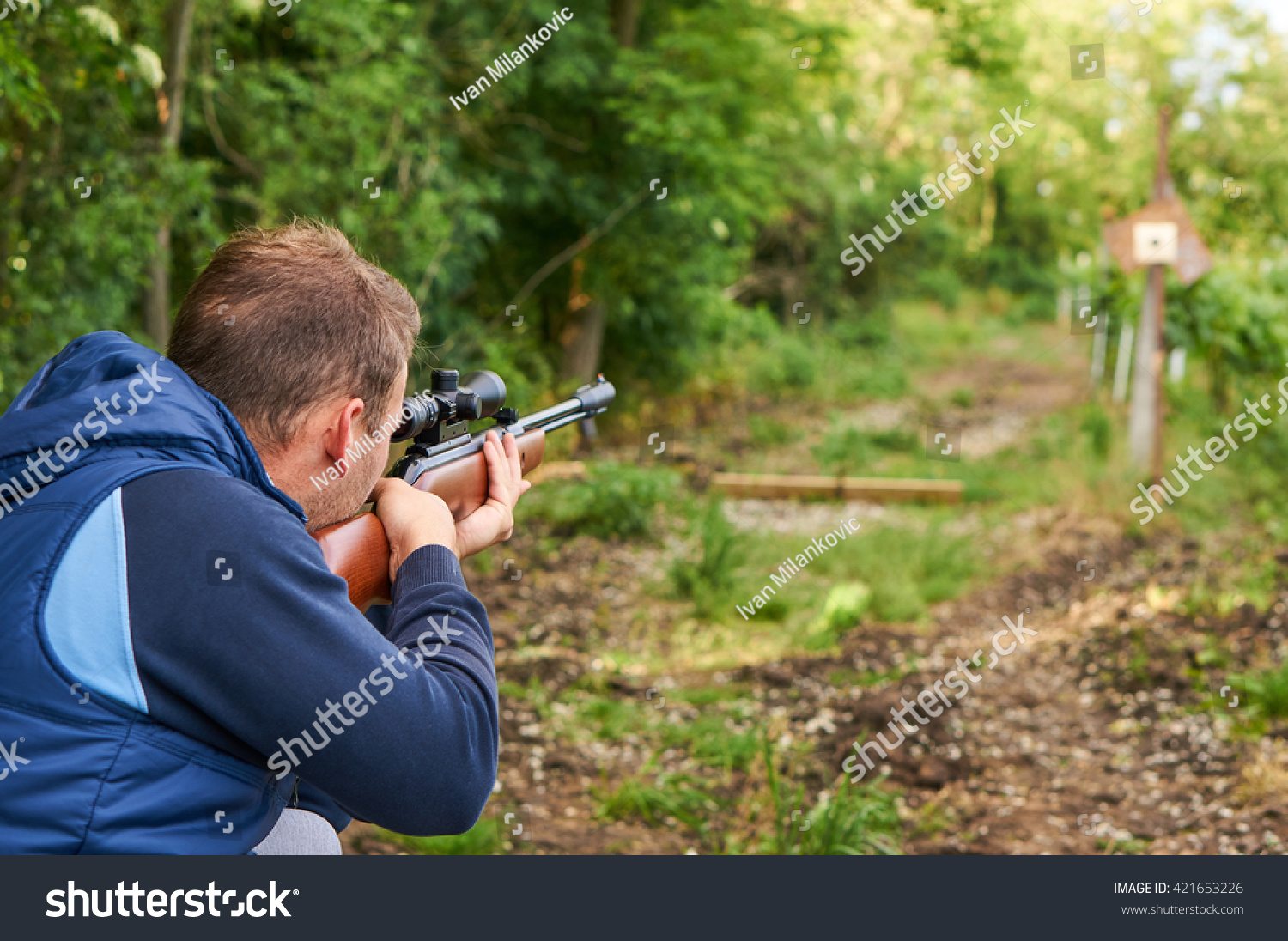 Стоковая фотография 421653226: Young Man Shoot Air Rifle - Stock Photo Young Man Shoot With Air Rifle 421653226