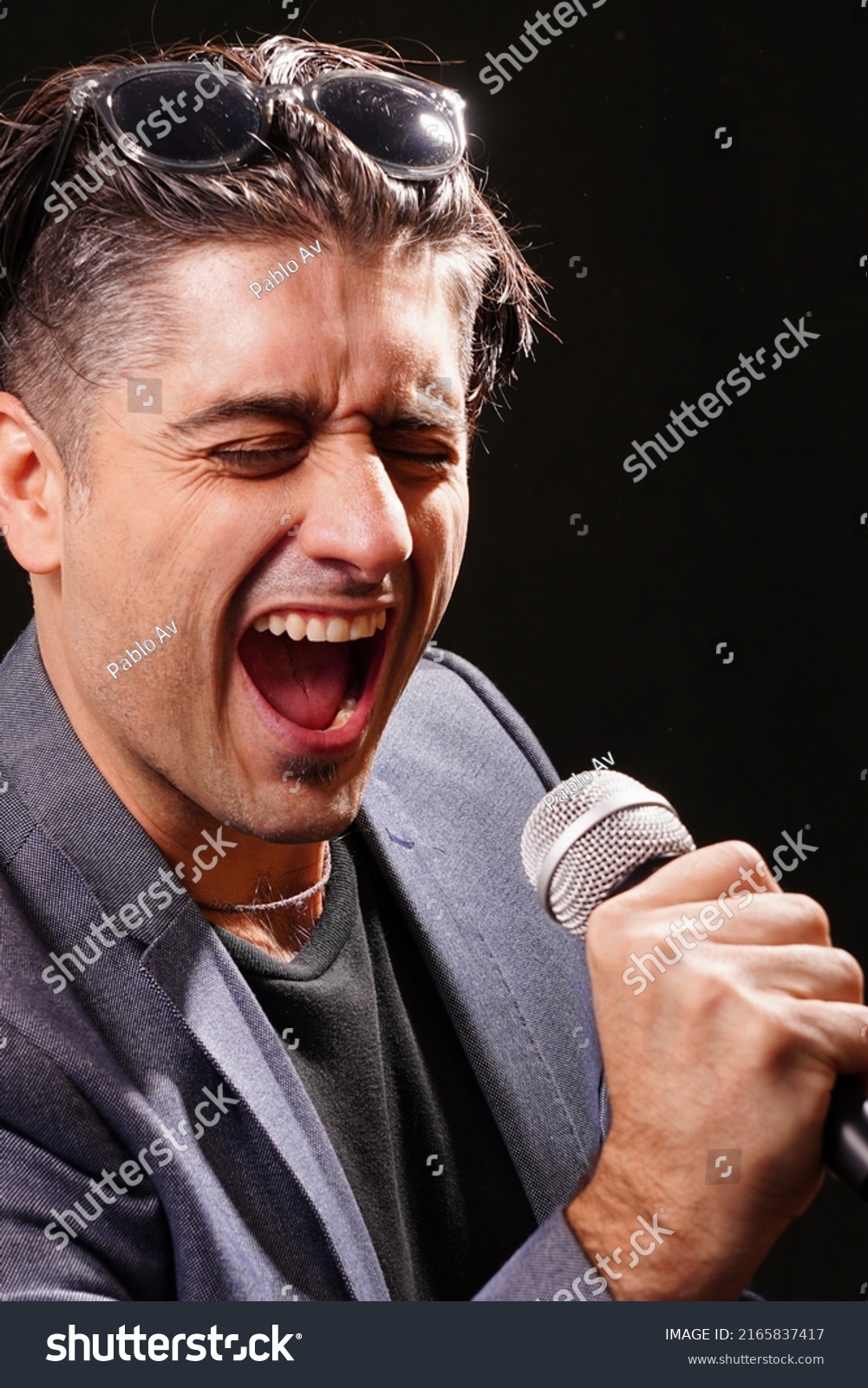 Young Man Singing Holding Microphone Black Stock Photo 2165837417