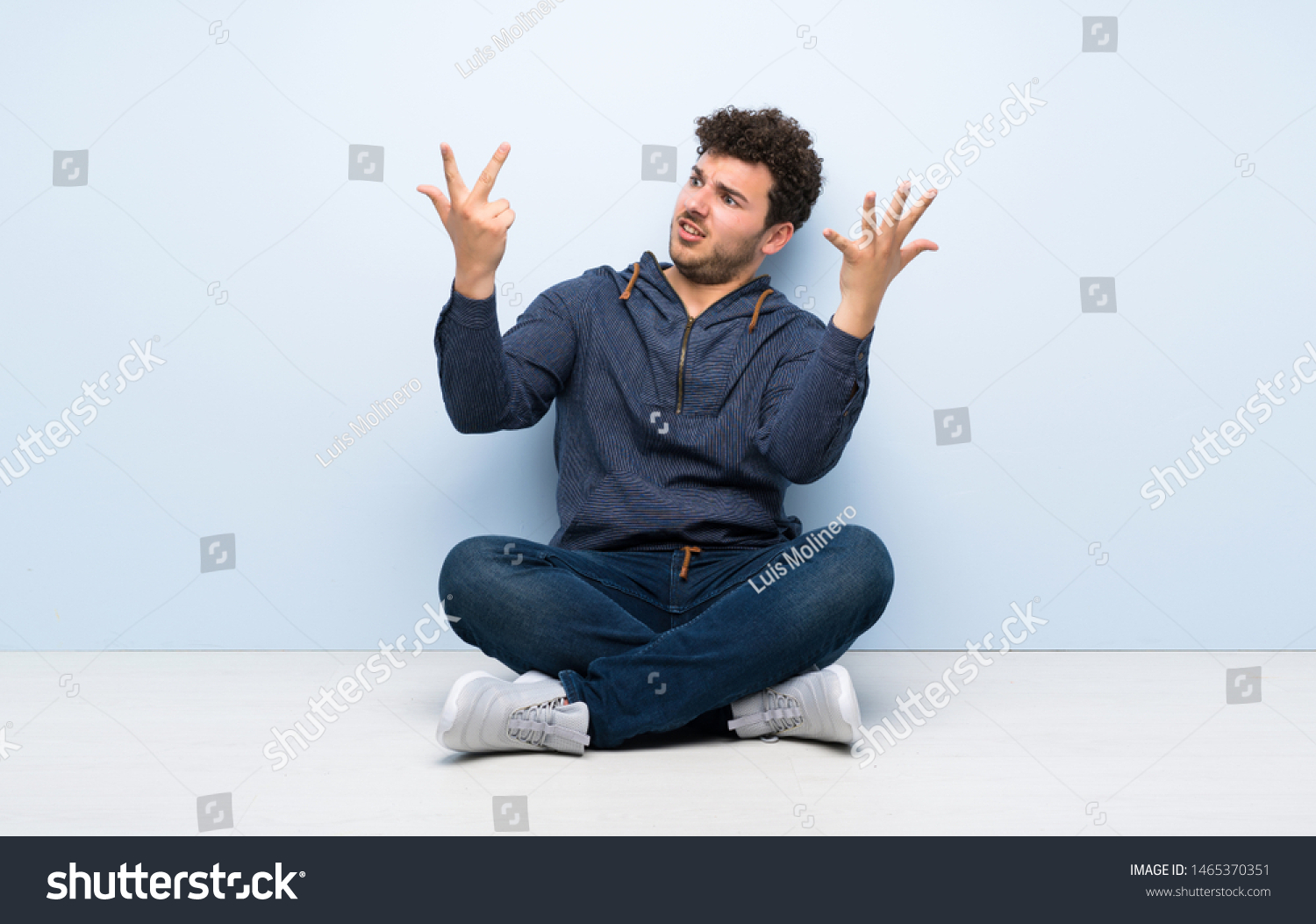 Young Man Sitting On Floor Counting Stock Photo 1465370351 