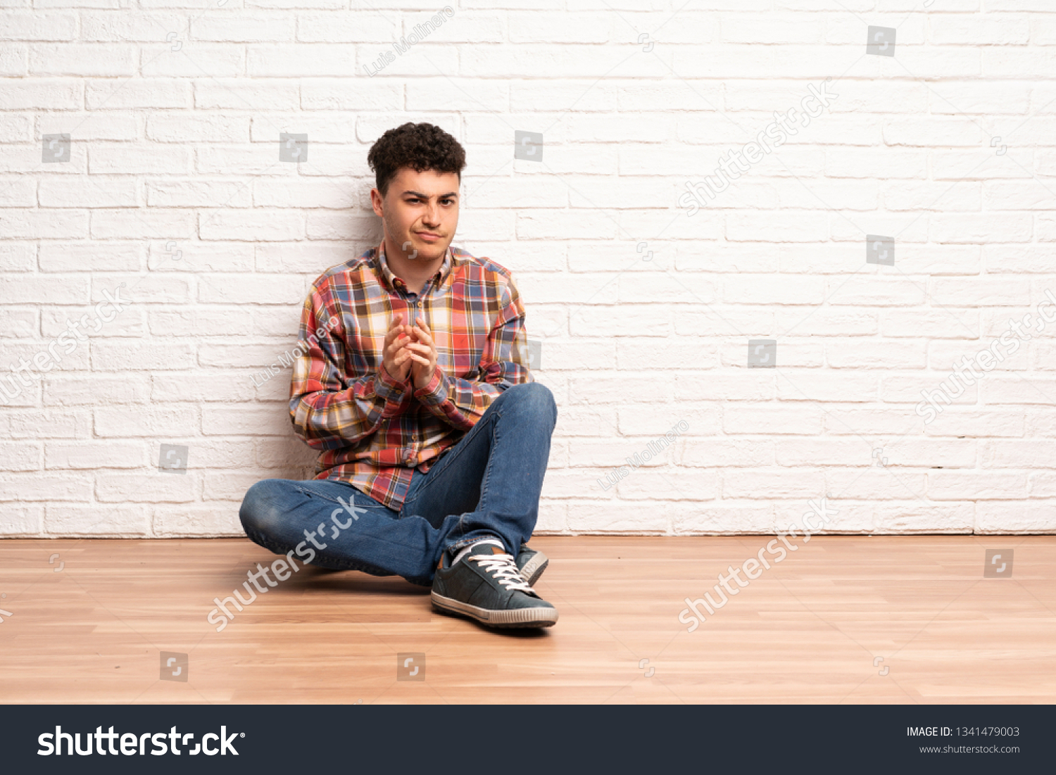 Young Man Sitting On Floor Scheming Stock Photo (edit Now) 1341479003