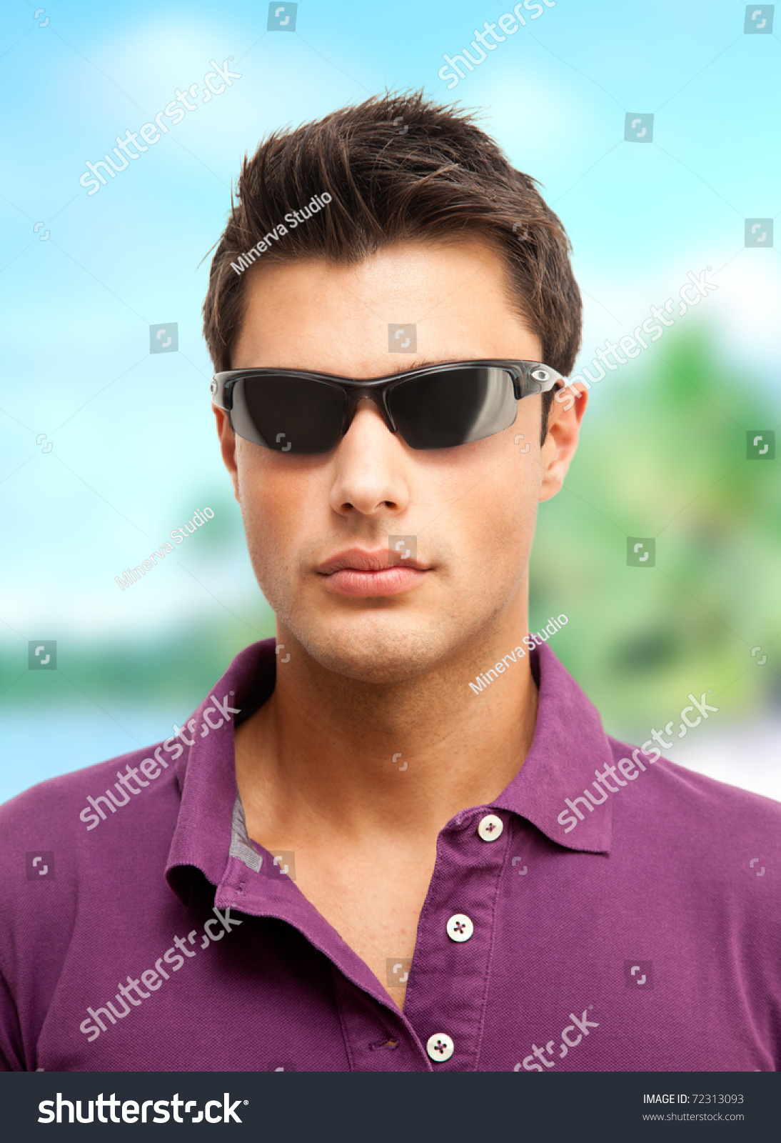 Young Man Wearing Sunglasses And A Purple Shirt Enjoying His Vacation ...