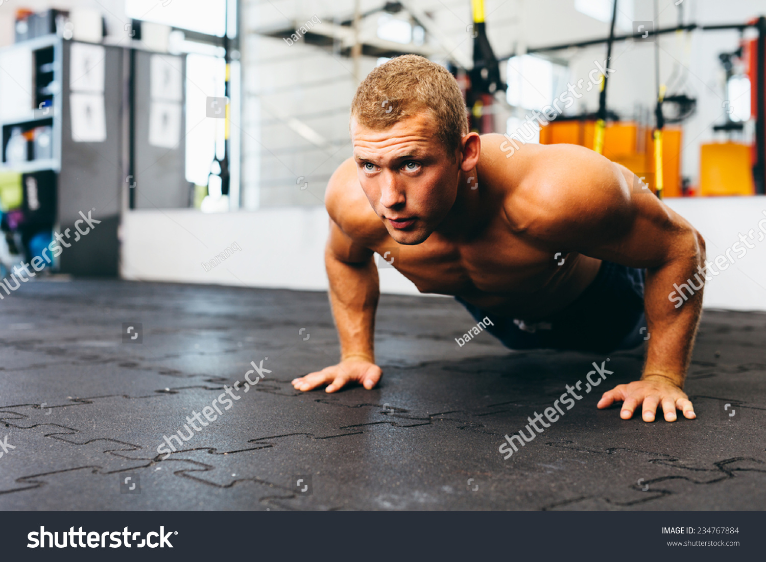 Young Muscular Athlete Practicing Suspension Pushups Stock Photo ...